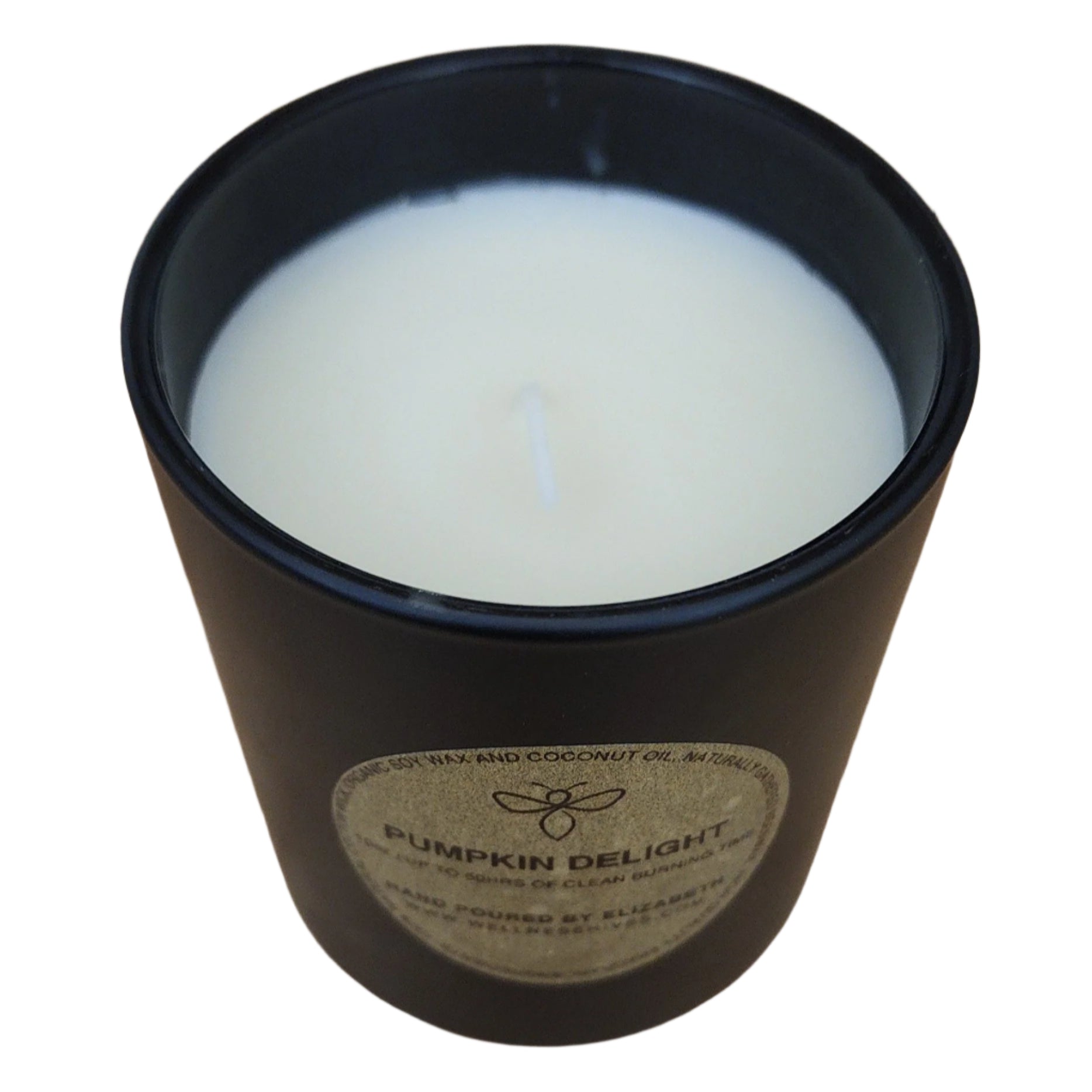 Top view of a Pumpkin Delight candle, showcasing the smooth white surface of the organic soy wax inside a black jar with a gold label. The candle is hand-poured, made from organic ingredients, and offers a clean burn.
